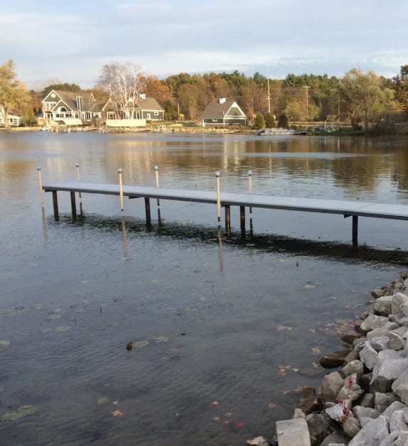 Boat Dock surrounded by the lake and houses